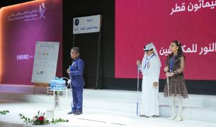 Three young students on a stage