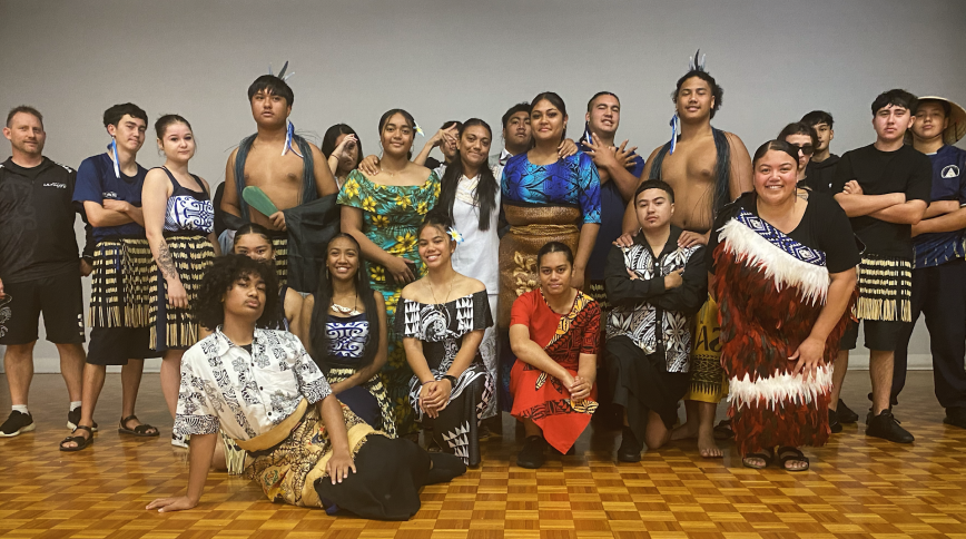 A group of teenagers and young adults in traditional indigenous attire